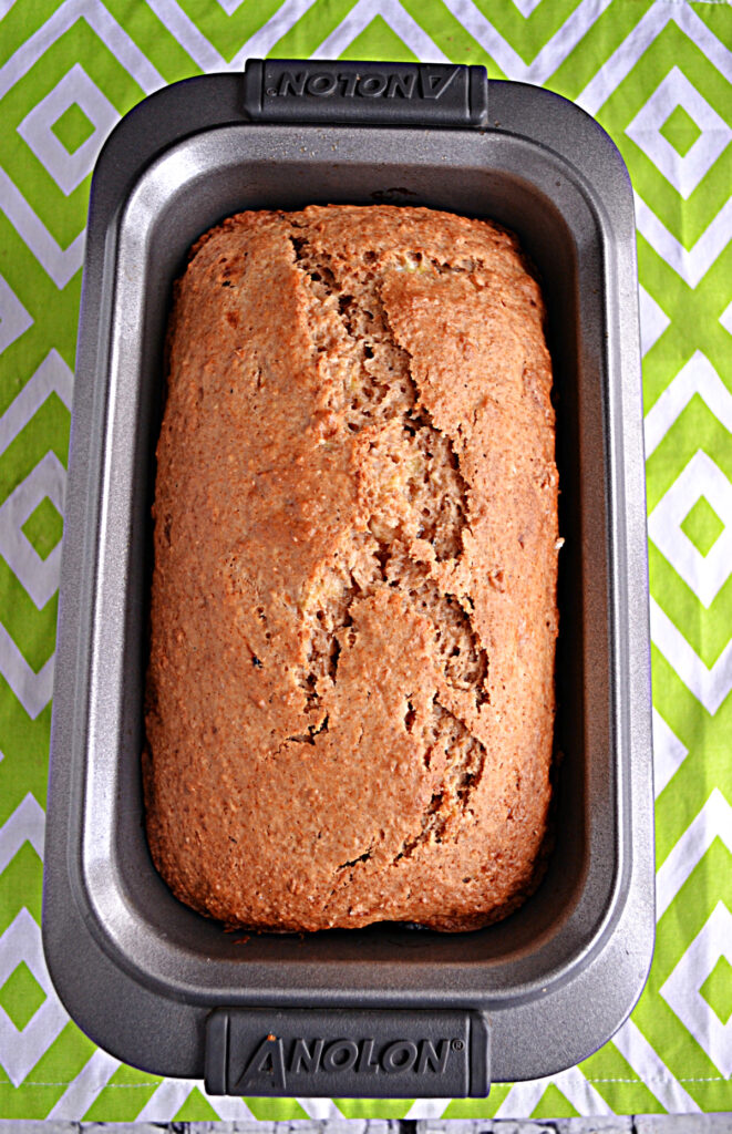 A loaf pan with banana bread in it.