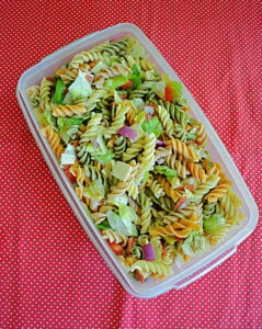 A container filled with pasta salad.