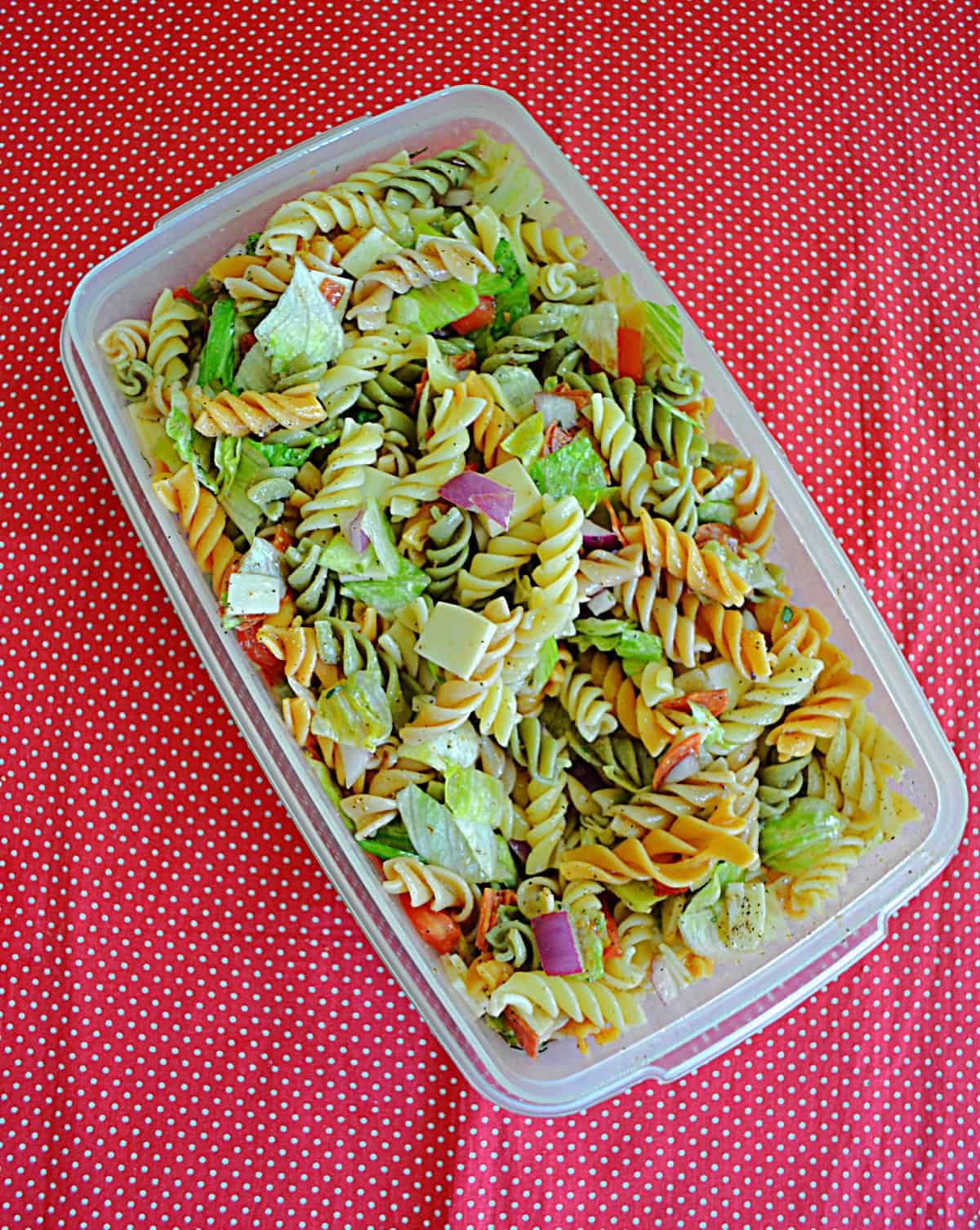 A container filled with pasta salad. 