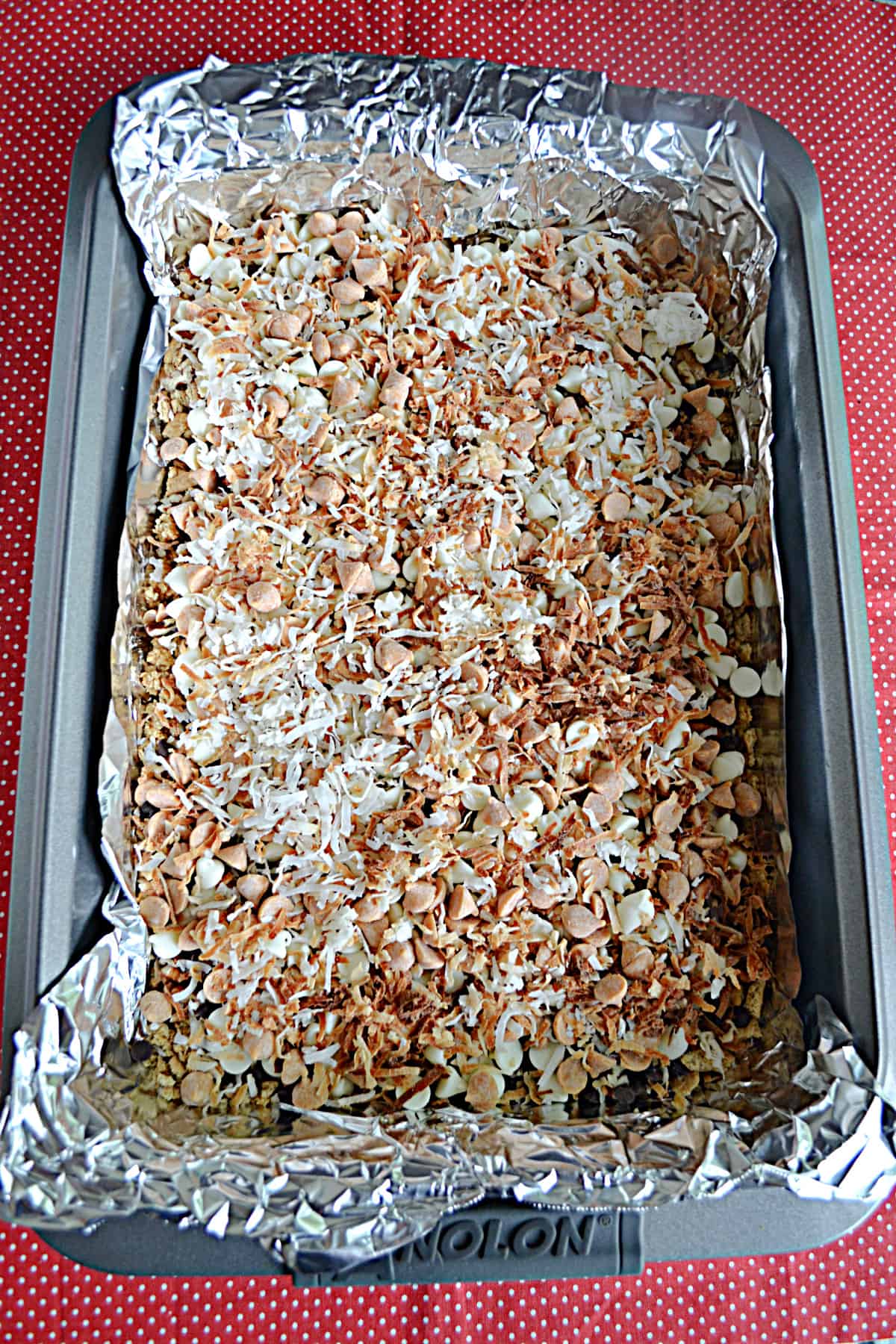 A pan of 7 layer bars ready for the oven. 