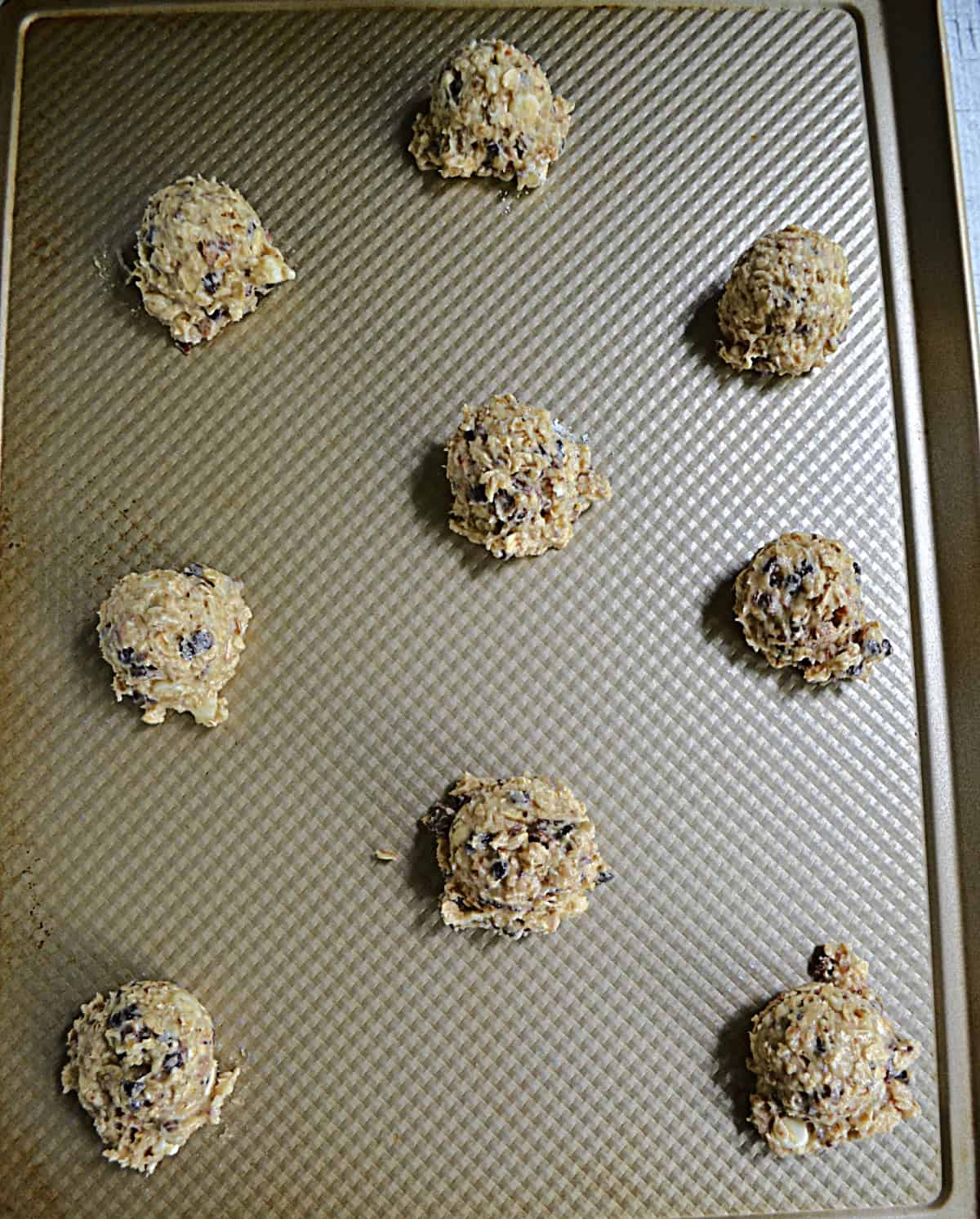 A baking sheet with cookie dough on it.