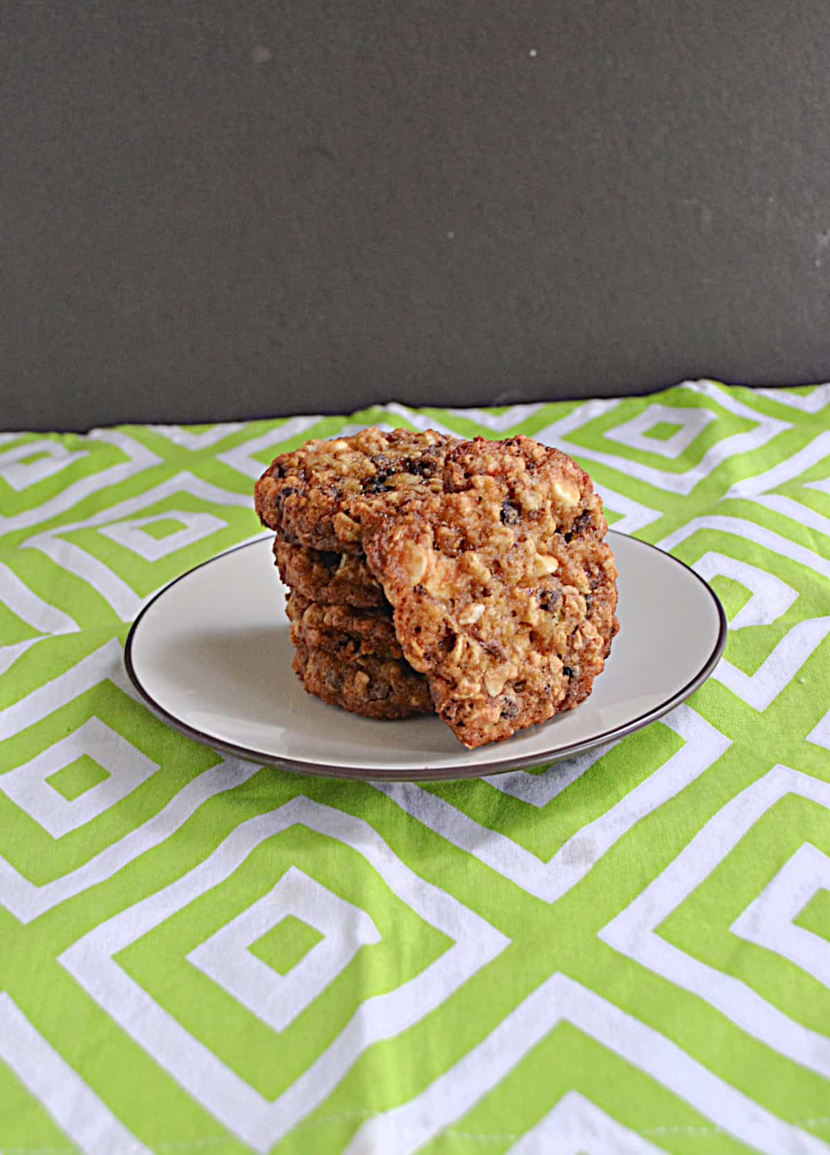 A plate of cookies with one cookie facing the camera.