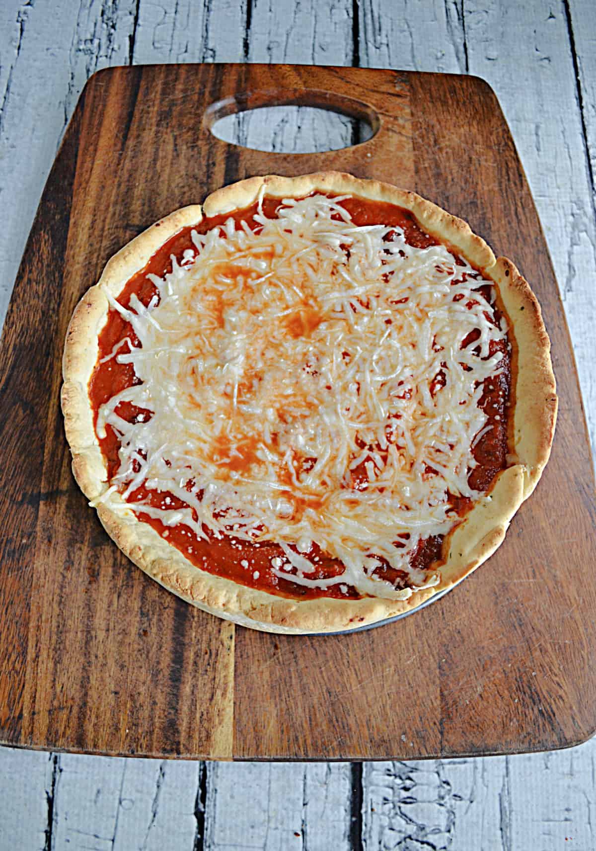 A baked deep dish pizza with cheese on top.