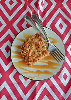 A slice of coffee cake on a plate with two forks.