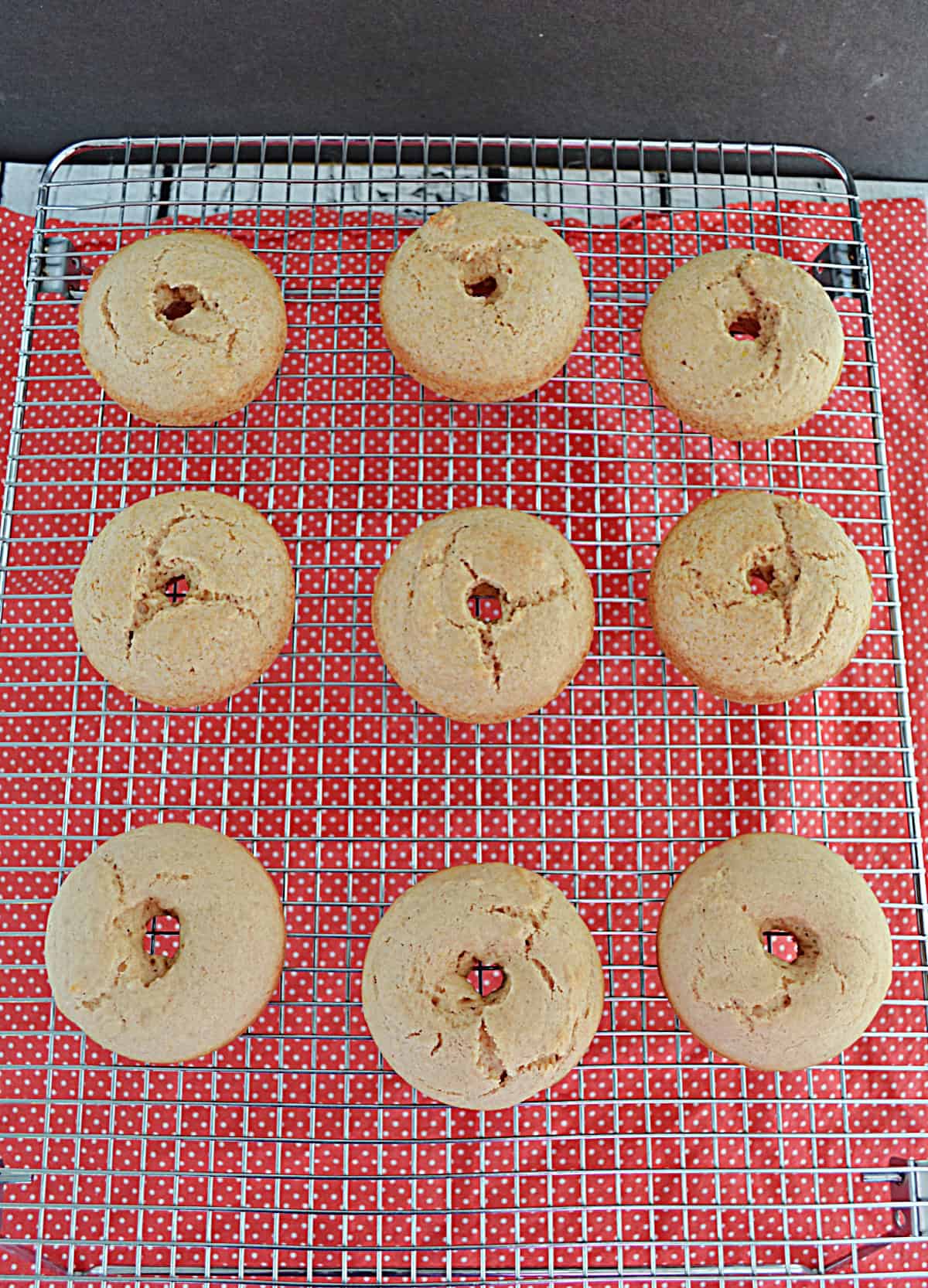Baked donuts on a cooling rack.