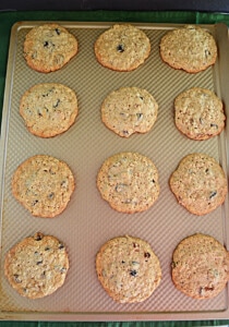 A baking sheet with 12 cookies on it.