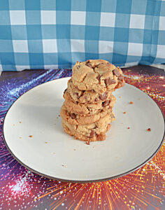 A stack of chocolate chip cookies on a plate.
