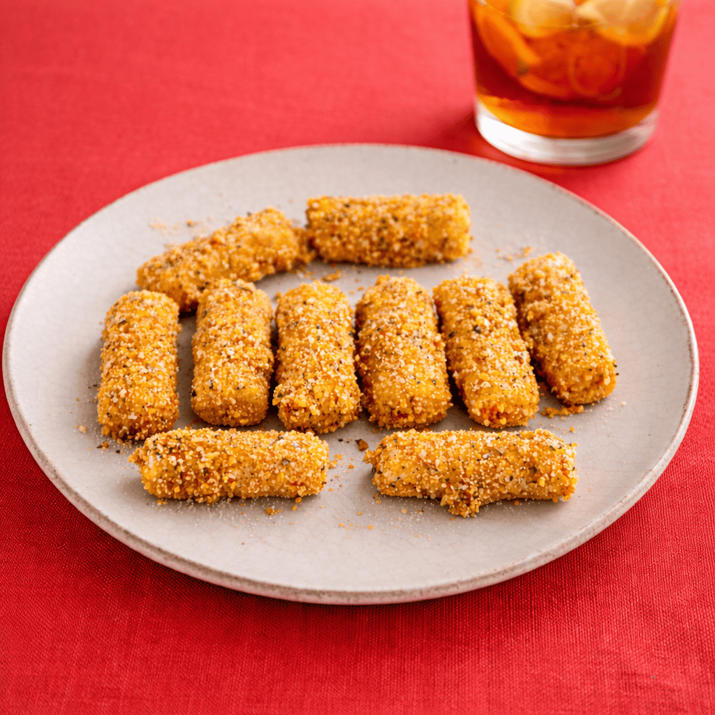 A plate of fried mozzarella sticks and a glass of iced tea.