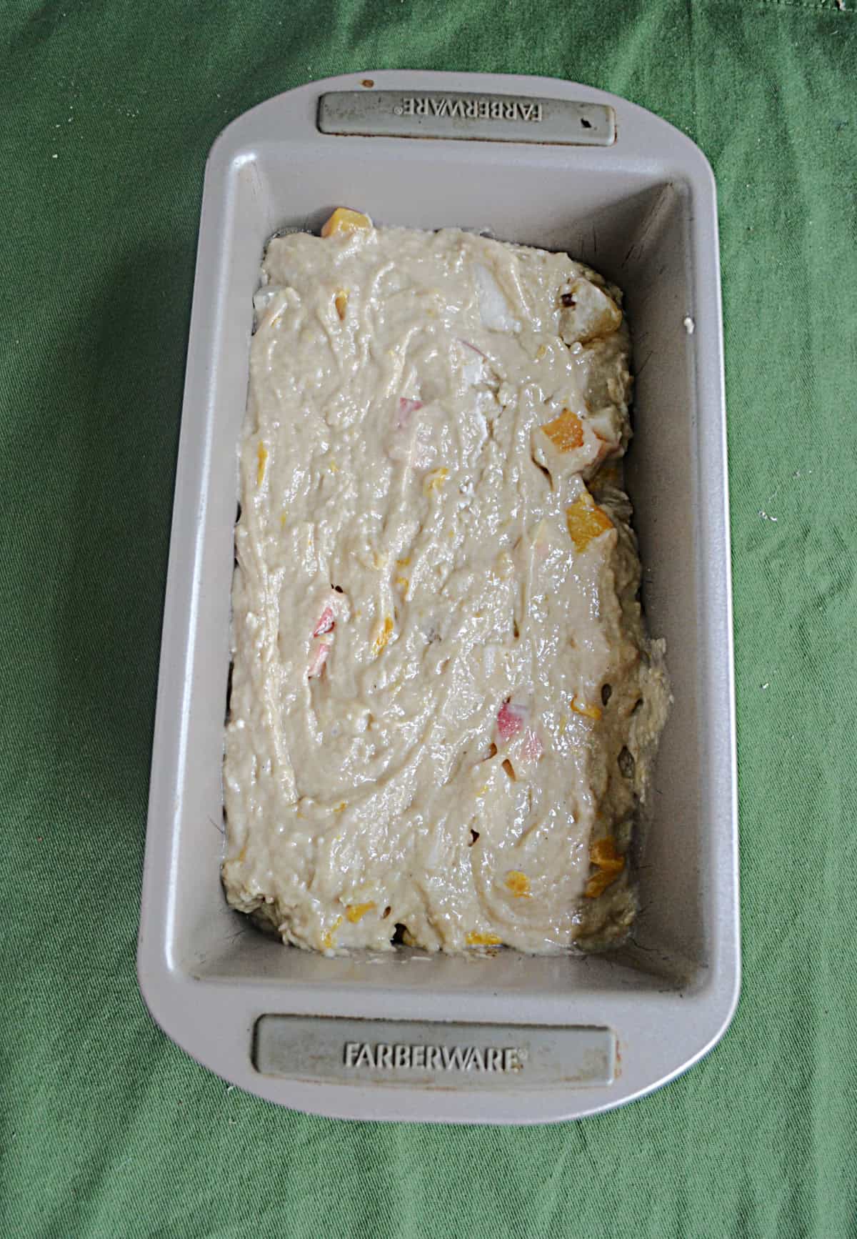 A bread pan with batter in it.