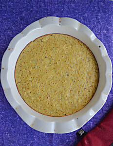 A pie pan with cornbread in it.