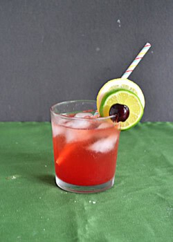 A glass with a pink cocktail in it with a straw in the glass.