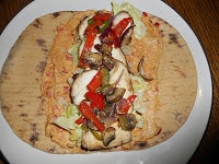 Just a few quick steps make an incredible Chicken, Hummus, and Veggie wrap!