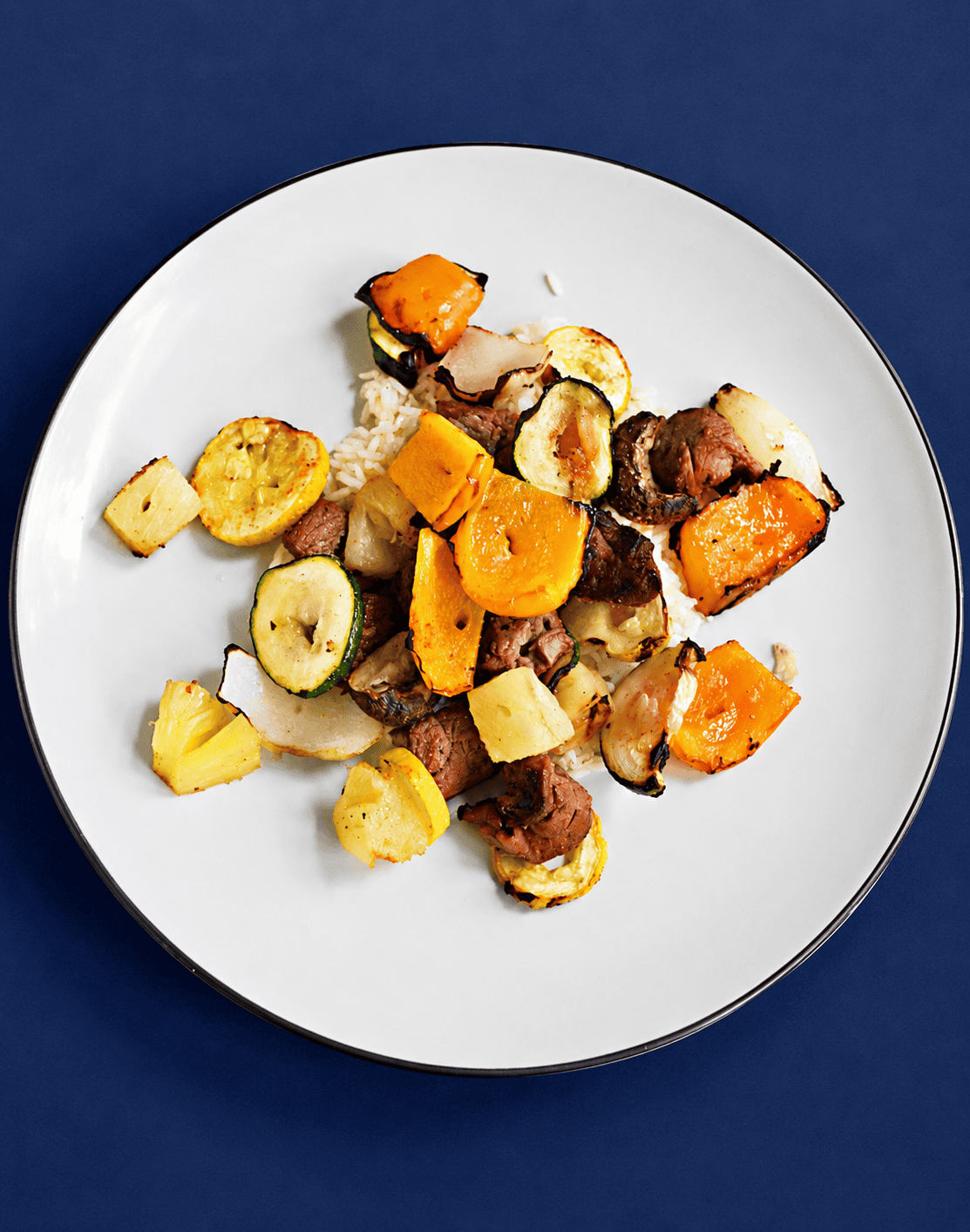 A plate of grilled vegetables and beef.