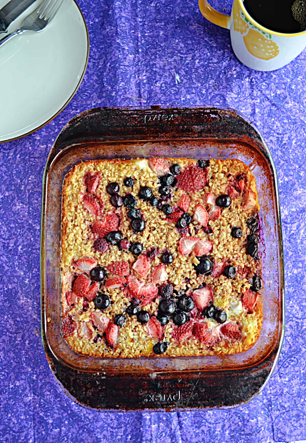 A pan of baked oatmeal topped with berries.