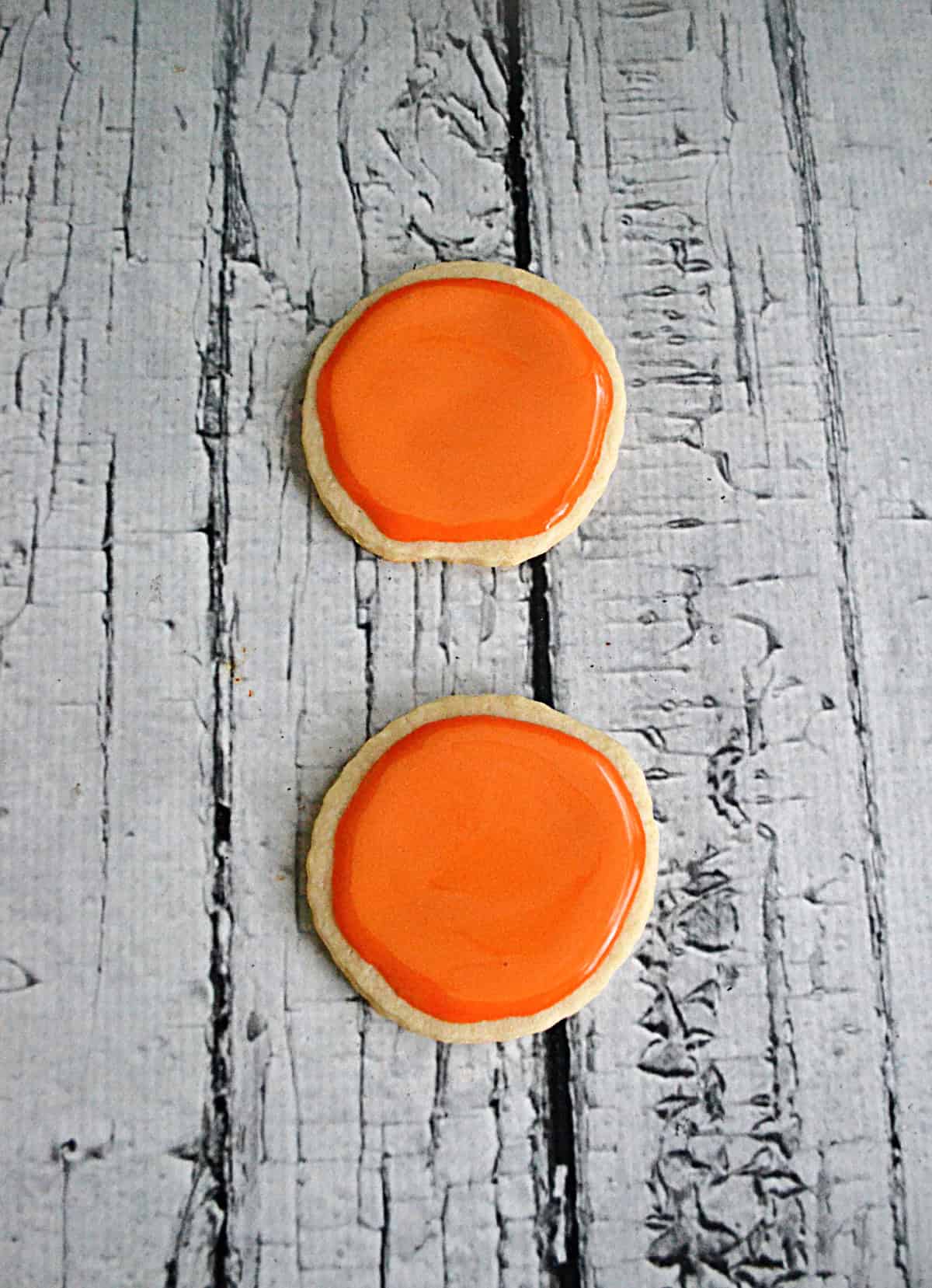 Cookies with orange icing on them. 