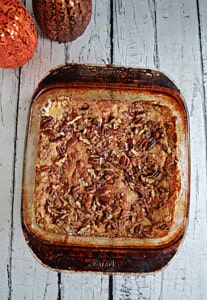 Pumpkin Crunch Cake in a pan with pecans on top.
