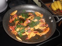 Apples, bacon, and spinach make a delicious topping for ravioli