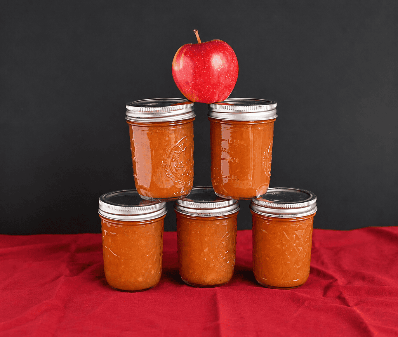 A pyramid of apple butter jars.