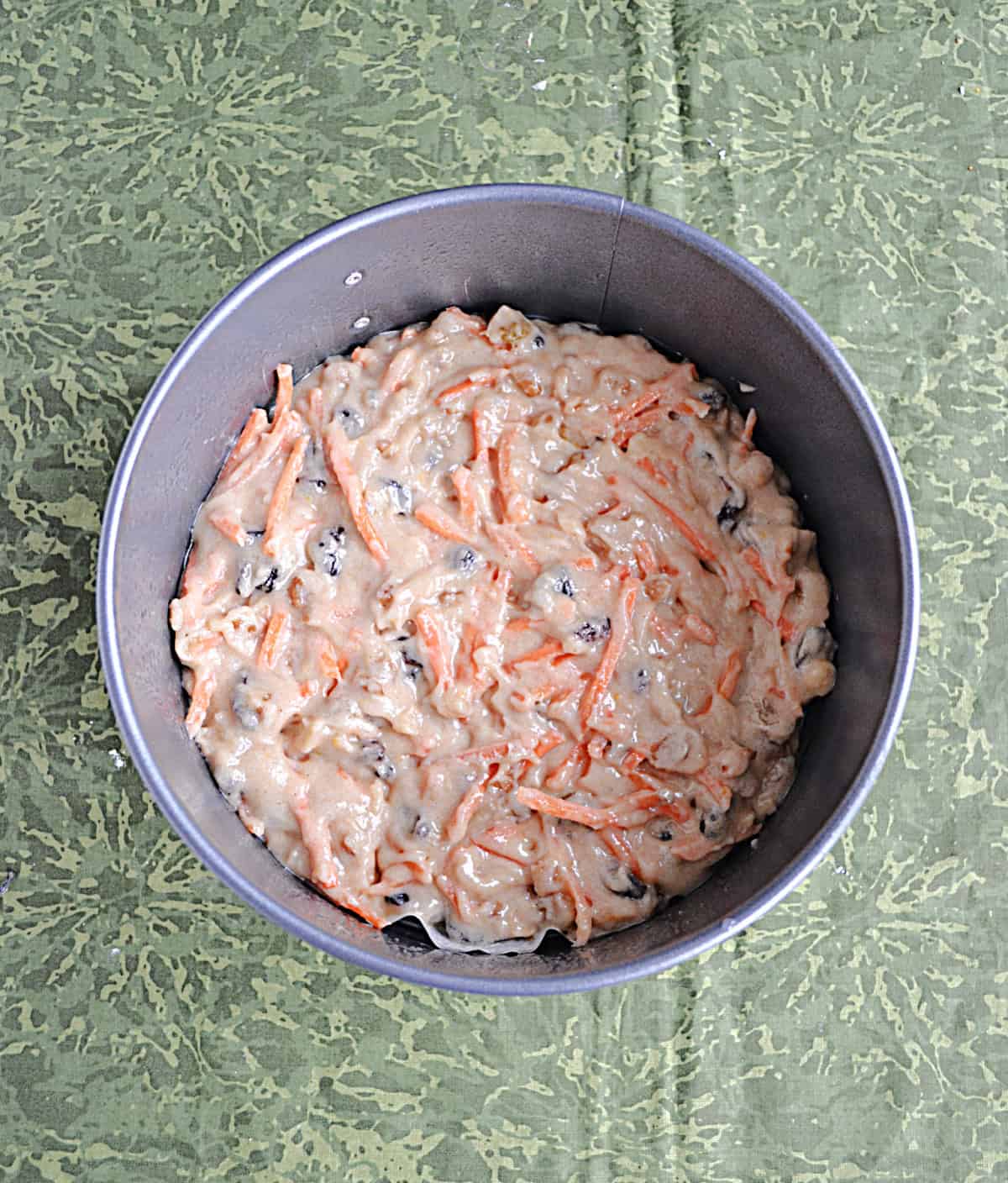A cake pan with carrot cake batter in it. 