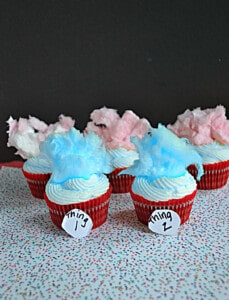 A bunch of Thing 1 & Thing 2 cupcakes with blue and pink cotton candy hair.