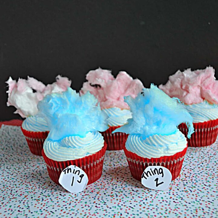 A bunch of Thing 1 & Thing 2 cupcakes with blue and pink cotton candy hair.