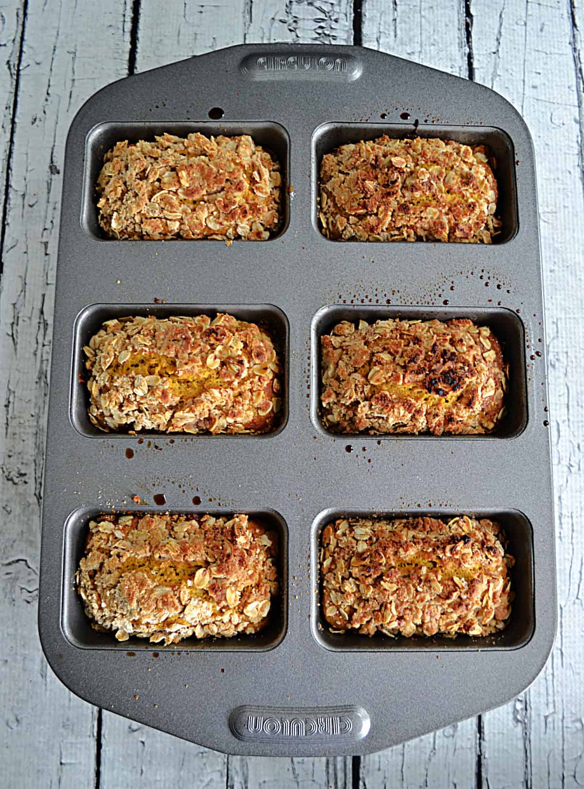 A pan with 6 mini loaves of bread in it.