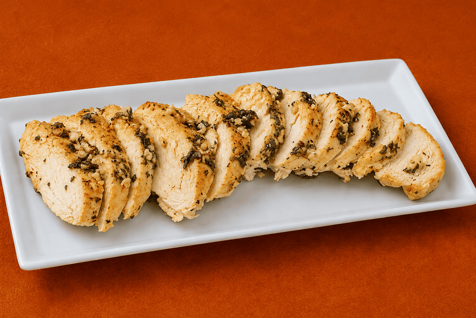 A sliced turkey tenderloin on a platter.