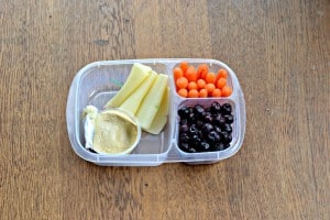 Balanced Bento with hummus, Alpine Lace Deli cheese, fresh berries, and carrots.
