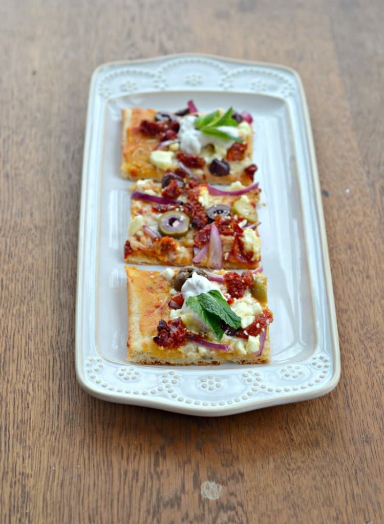 Mediterranean Flatbread with olives, sun dried tomatoes, red onions, feta, and Sabra hummus