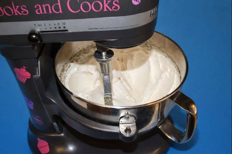 A mixer with the nougat mixture in the bowl.