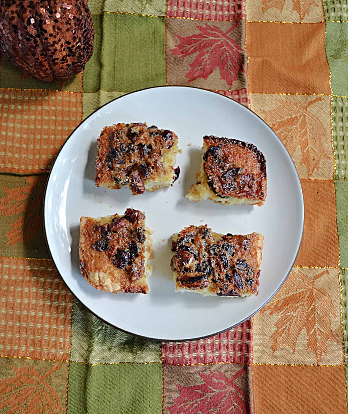 A plate with four cranberry squares on them.