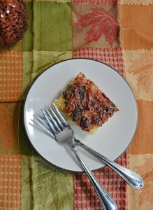 A plate with a cranberry maple bar and two forks.