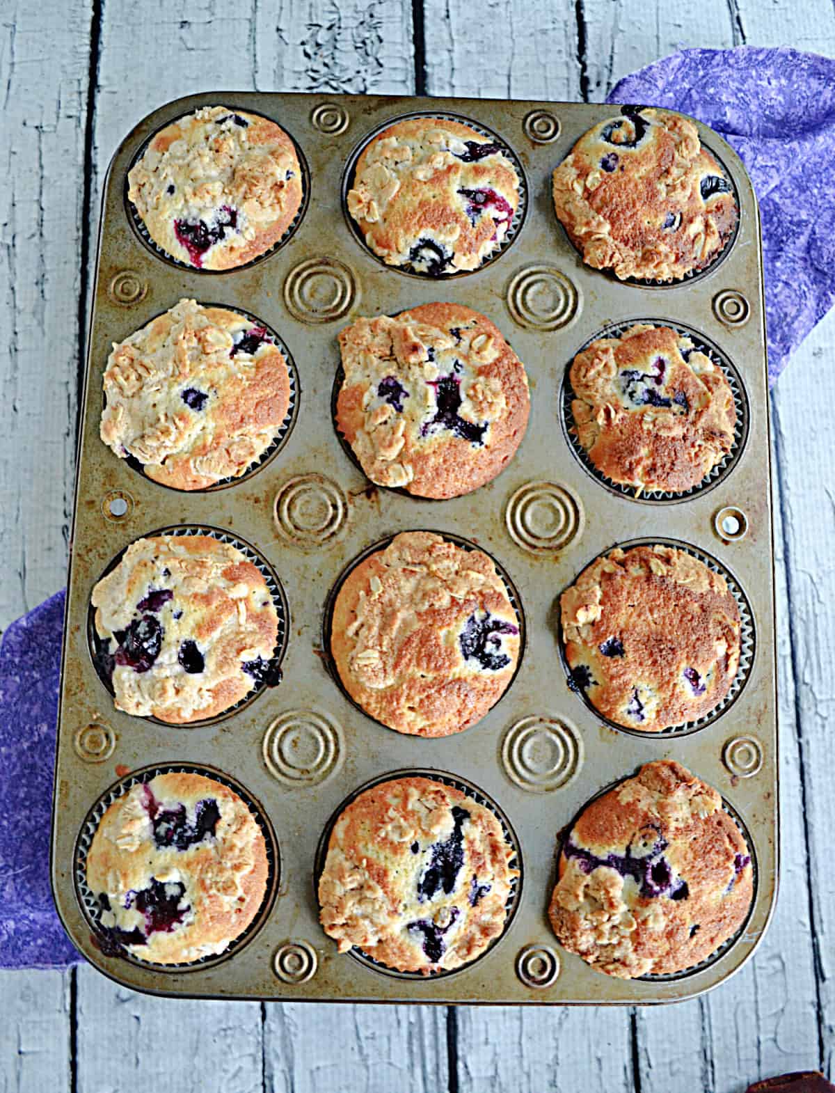 Golden brown muffins in a muffin tin.