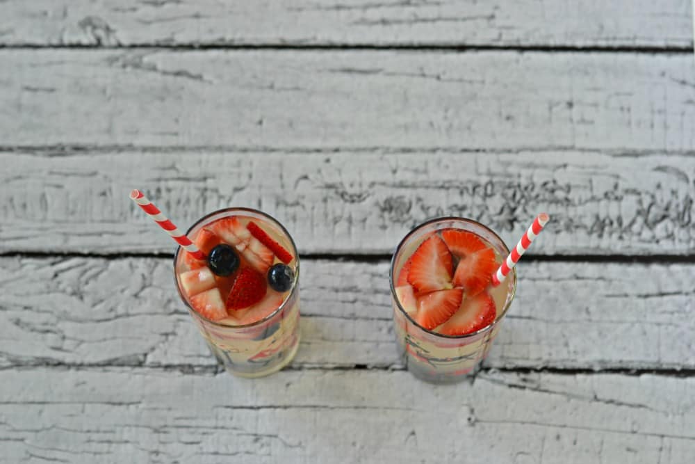 Red, White, and Blue Sangria with strawberries and blueberries