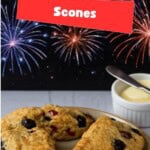 Pin Image: A plate of scones with a bowl of butter and a knife.
