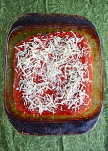 A baking dish of eggplant layered with cheese and sauce.