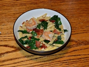 Shrimp and Bacon Pasta is tossed with spinach and a light sauce.