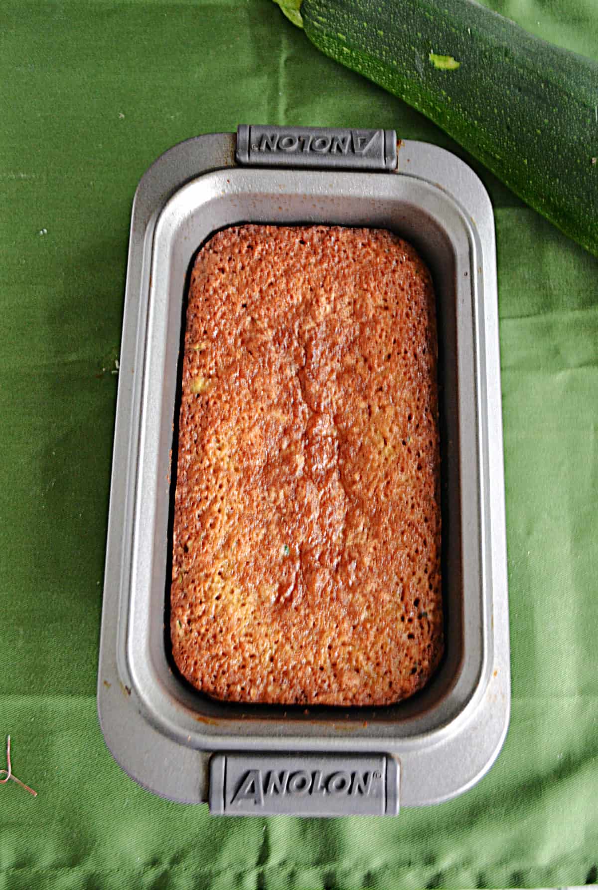 A bread pan with zucchini bread in it. 