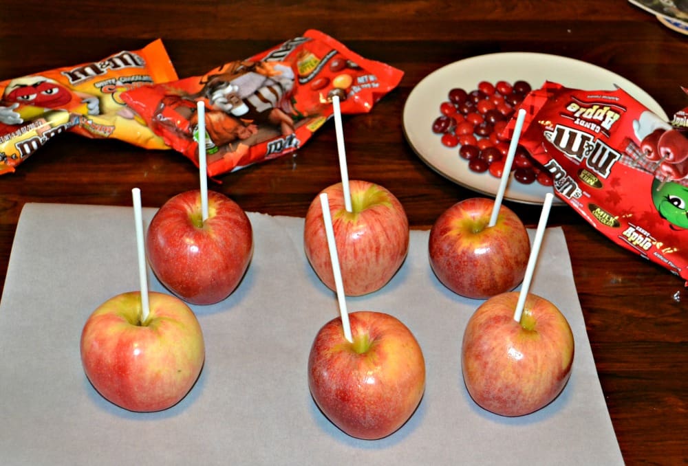 Apples Coated in chocolate then covered in fall flavor M&M's.