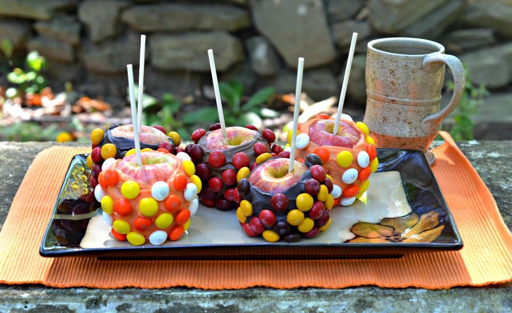 Delicious Chocolate Covered Apples covered with fall flavored M&M's and Mott's Hot Apple Juice Cider