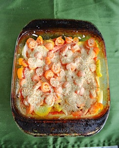 A baking dish full of vegetables with breadcrumbs on top.