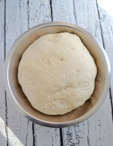 A bowl of dough that has risen.