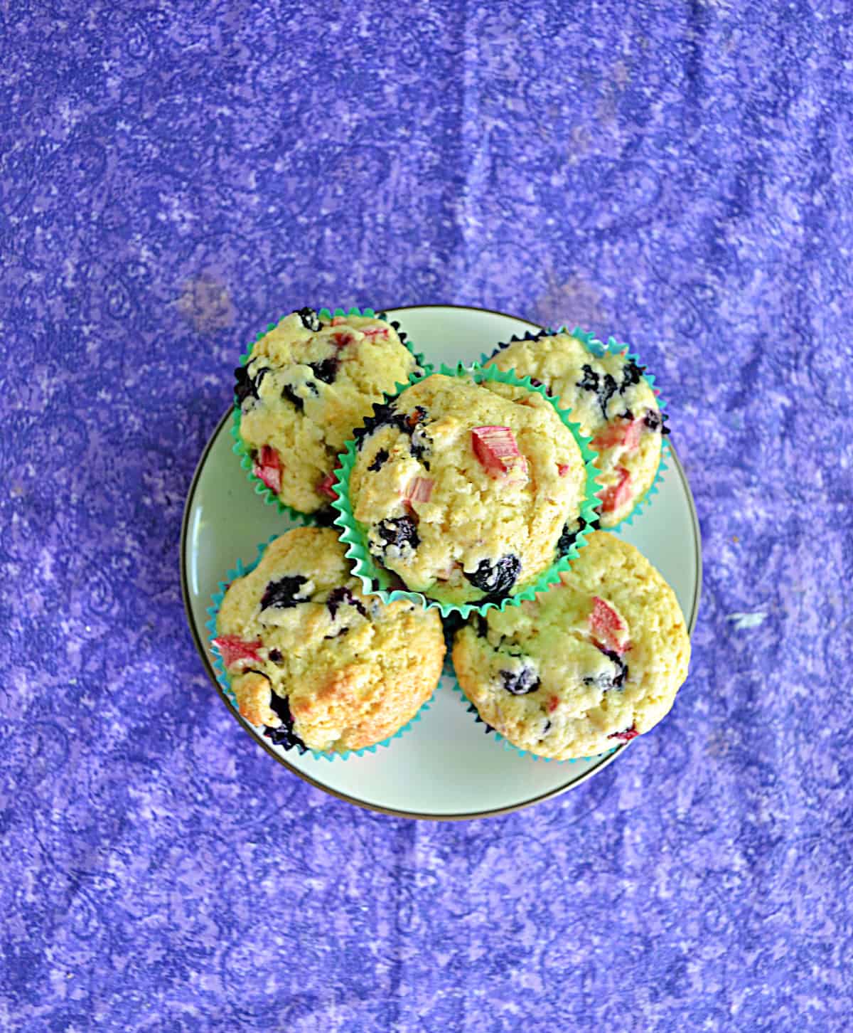 A plate piled with blueberry muffins.