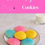 Pin Image: Title, a plate of pastel colored cookies with a glass of milk in the background.