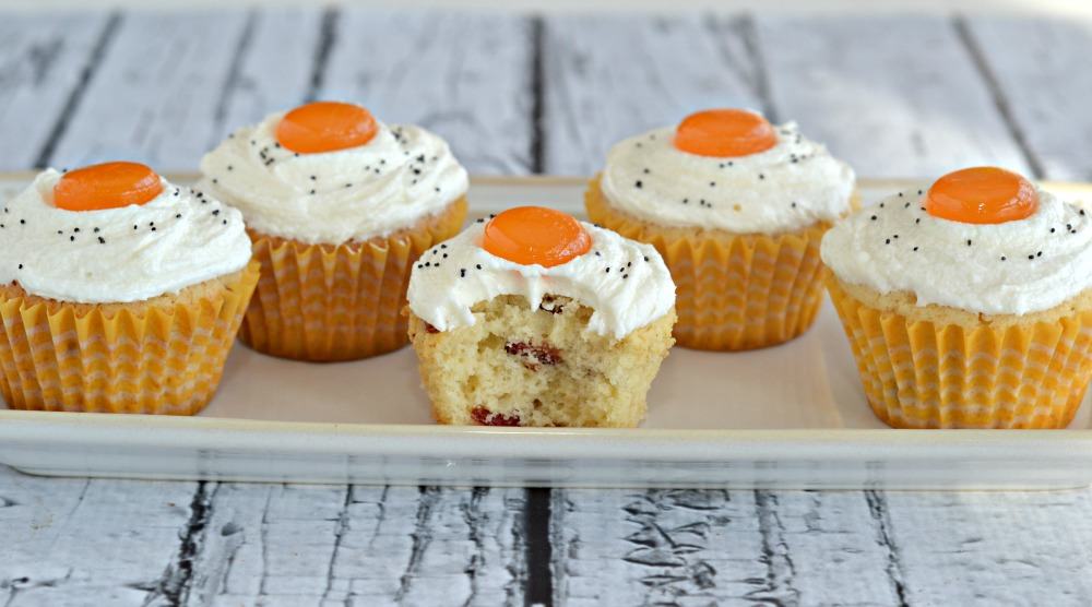 Sweet and salty bacon cupcakes topped with sweet buttercream frosting that looks like a sunny side up egg.