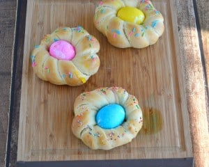 Fabulous Individual Easter Egg Bread with sprinkles on top and dyed Easter eggs in the middle