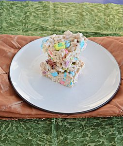 A top view of a stack of Lucky Charms Treats on a plate.