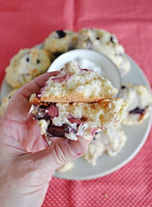 A close up of a hand holding a scone split open.