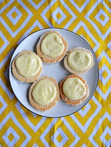 A plate of cookies with lemon curd and frosting on top.