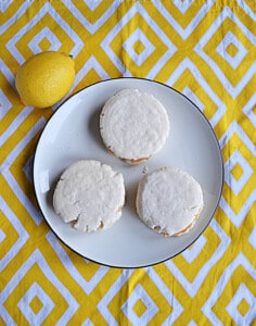 A plate of butter cookies with a lemon near them.